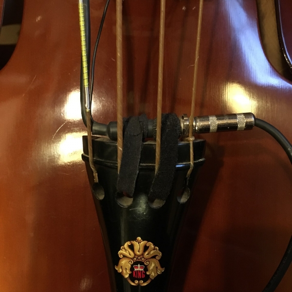 Double bass tailpiece with pickup output and cable.