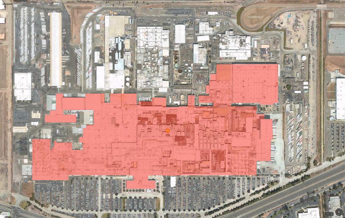 Arial photo of the Tesla Factory in Fremont, CA. with the building perimeter highlighted in red
